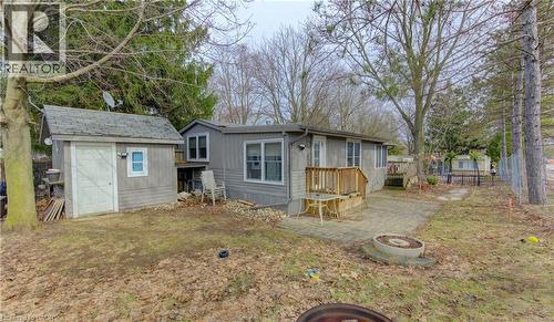 Back of house with a shed, an outdoor fire pit, a patio, and a wooden deck - 580 Beaver Creek Road Unit# 11, Waterloo, ON - Outdoor
