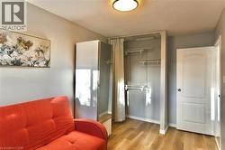 Bedroom with a closet, light wood-type flooring, and a textured ceiling - 