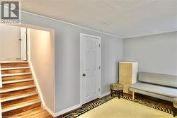 Sitting room with wood finished floors and a textured ceiling - 