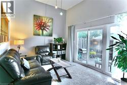 Living room with wood finished floors and a high ceiling - 