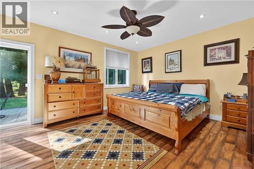 Bedroom featuring access to exterior, wood finished floors, a ceiling fan, and recessed lighting - 5590 Blind Line, Burlington, ON - Indoor Photo Showing Bedroom