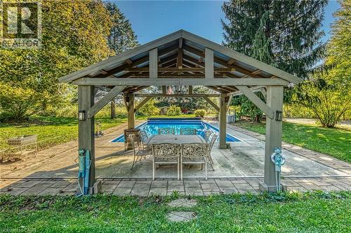 View of patio / terrace with an outdoor pool and outdoor dining space - 5590 Blind Line, Burlington, ON - Outdoor With In Ground Pool