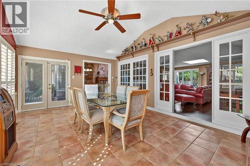 Dining space featuring french doors, lofted ceiling, ceiling fan, and light tile patterned floors - 5590 Blind Line, Burlington, ON - Indoor Photo Showing Dining Room