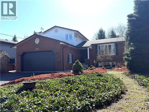 View of front of property with a garage, brick siding, and driveway - 567 Rustic Drive, Waterloo, ON - Outdoor