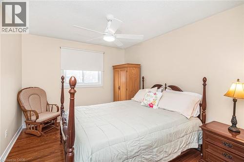 Bedroom featuring a ceiling fan, dark wood-type flooring, and a textured ceiling - 40 Artistic Boulevard, Hamilton, ON - Indoor Photo Showing Bedroom