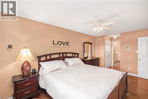 Bedroom with a closet, ensuite bath, dark wood finished floors, and ceiling fan - 40 Artistic Boulevard, Hamilton, ON - Indoor Photo Showing Bedroom
