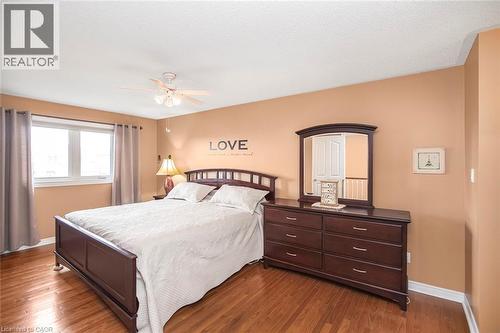 Bedroom with dark wood-type flooring and ceiling fan - 40 Artistic Boulevard, Hamilton, ON - Indoor Photo Showing Bedroom