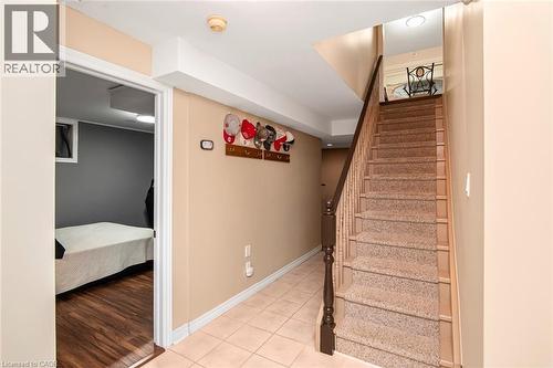 Staircase with baseboards and tile patterned floors - 40 Artistic Boulevard, Hamilton, ON - Indoor Photo Showing Other Room