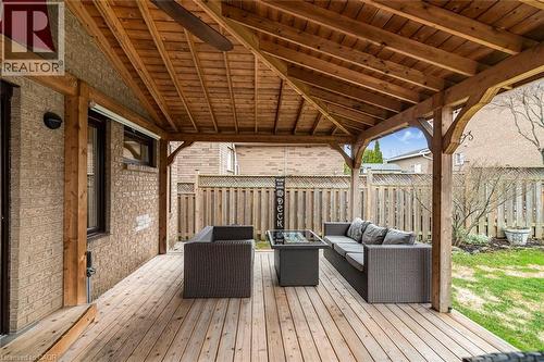 Wooden terrace with an outdoor living space with a fire pit, a fenced backyard, and ceiling fan - 40 Artistic Boulevard, Hamilton, ON - Outdoor With Deck Patio Veranda With Exterior