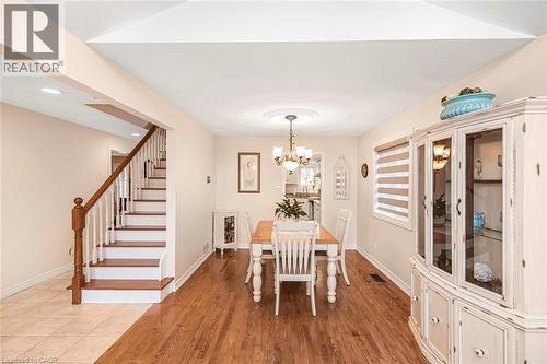 Dining space featuring suspended lighting and light wood finished floors - 40 Artistic Boulevard, Hamilton, ON - Indoor