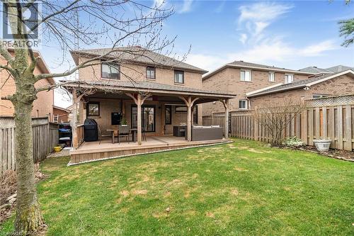 Back of house with a fenced backyard, brick siding, a wooden deck, and an outdoor hangout area - 40 Artistic Boulevard, Hamilton, ON - Outdoor With Deck Patio Veranda
