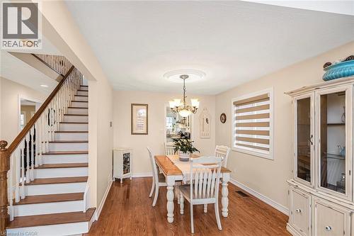 Dining room featuring wood finished floors and suspended lighting - 40 Artistic Boulevard, Hamilton, ON - Indoor Photo Showing Dining Room