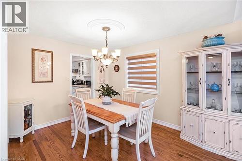 Dining area featuring suspended lighting and wood finished floors - 40 Artistic Boulevard, Hamilton, ON - Indoor Photo Showing Dining Room