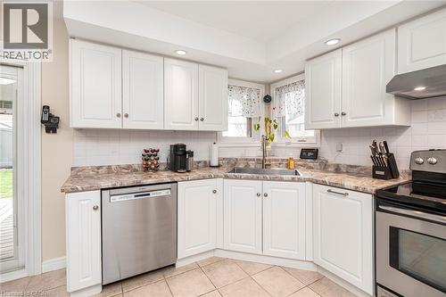 Kitchen featuring stainless steel appliances, white cabinets, backsplash, light tile patterned floors, and recessed lighting - 40 Artistic Boulevard, Hamilton, ON - Indoor Photo Showing Kitchen
