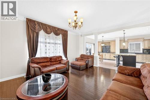 Living area featuring ornate columns, ornamental molding, light wood-style floors - 182 Irwin Avenue, Hamilton, ON - Indoor Photo Showing Living Room
