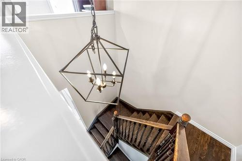 Stairs with a chandelier - 182 Irwin Avenue, Hamilton, ON - Indoor Photo Showing Other Room