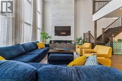 Living area featuring a high ceiling and wood finished floors - 