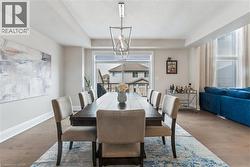 Dining area featuring wood finished floors, a textured ceiling, and a raised ceiling - 