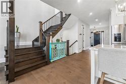 Stairway with hanging lights and wood finished floors - 