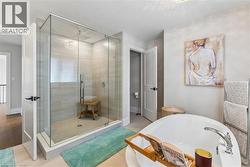 Bathroom with a stall shower, a bath, and wood finished floors - 