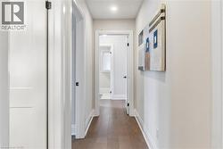 Corridor with baseboards and dark wood finished floors - 