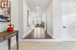 Corridor with recessed lighting and light tile patterned flooring - 