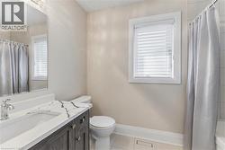Bathroom with vanity and light tile patterned floors - 