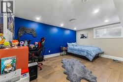 Bedroom featuring a desk, light wood-style floors, and recessed lighting - 