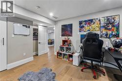 Office area with light wood-type flooring and baseboards - 
