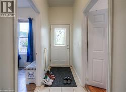 Doorway to outside with baseboards and tile patterned floors - 