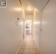 Hallway with light tile patterned flooring and baseboards - 