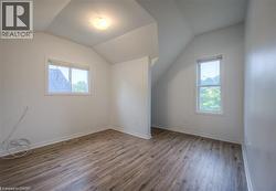 Bonus room featuring light wood finished floors and vaulted ceiling - 