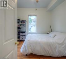 Bedroom with light wood finished floors and ceiling fan - 