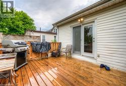 Wooden terrace featuring a grill - 