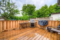 Wooden terrace featuring area for grilling - 
