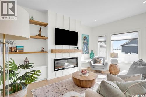 9 437 Palmer Crescent, Warman, SK - Indoor Photo Showing Living Room With Fireplace