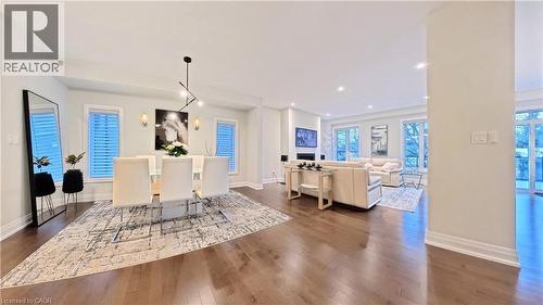 Dining area with dark wood-style flooring and baseboards - 63 Ian Ormston Drive, Kitchener, ON - Indoor
