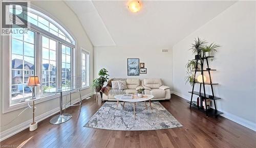 Living area featuring lofted ceiling and dark wood-style flooring - 63 Ian Ormston Drive, Kitchener, ON - Indoor Photo Showing Living Room