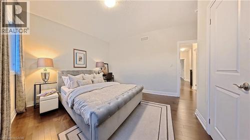 Bedroom featuring dark wood-style floors - 63 Ian Ormston Drive, Kitchener, ON - Indoor Photo Showing Bedroom