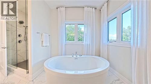 Bathroom with a marble finish shower, a freestanding bath, and light marble finish floors - 63 Ian Ormston Drive, Kitchener, ON - Indoor Photo Showing Bathroom