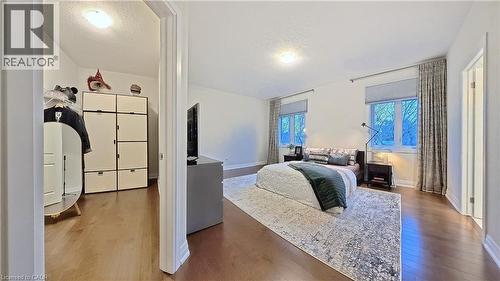 Bedroom with a textured ceiling and hardwood / wood-style flooring - 63 Ian Ormston Drive, Kitchener, ON - Indoor