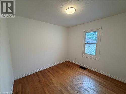 Unfurnished room featuring light wood-style flooring and a textured ceiling - 628 Dunn Avenue, Hamilton, ON - Indoor Photo Showing Other Room