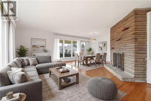 Living room featuring wood finished floors and a fireplace - 890 Falcon Boulevard, Burlington, ON - Indoor Photo Showing Living Room With Fireplace