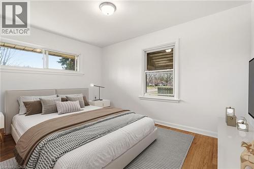 Bedroom featuring light wood-style flooring and baseboards - 890 Falcon Boulevard, Burlington, ON - Indoor Photo Showing Bedroom