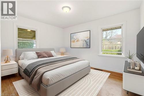 Bedroom with multiple windows and light wood-style floors - 890 Falcon Boulevard, Burlington, ON - Indoor Photo Showing Bedroom