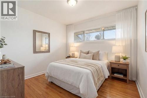 Bedroom with light wood-style floors and baseboards - 890 Falcon Boulevard, Burlington, ON - Indoor Photo Showing Bedroom