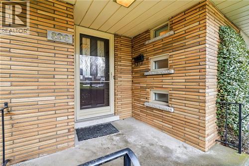 Doorway to property featuring brick siding and a porch - 890 Falcon Boulevard, Burlington, ON - Outdoor With Exterior