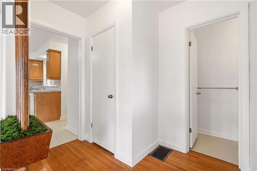 Corridor featuring light wood-style floors and baseboards - 890 Falcon Boulevard, Burlington, ON - Indoor Photo Showing Other Room