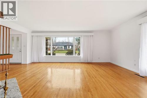 Unfurnished living room featuring light wood-type flooring and crown molding - 890 Falcon Boulevard, Burlington, ON - Indoor Photo Showing Other Room
