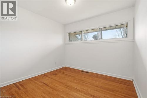 Empty room with baseboards and light wood finished floors - 890 Falcon Boulevard, Burlington, ON - Indoor Photo Showing Other Room
